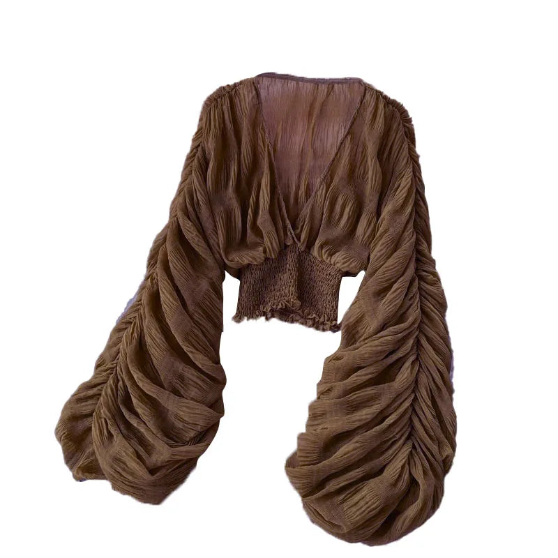 Blusa feminina de manga bufante longa e com dobras.